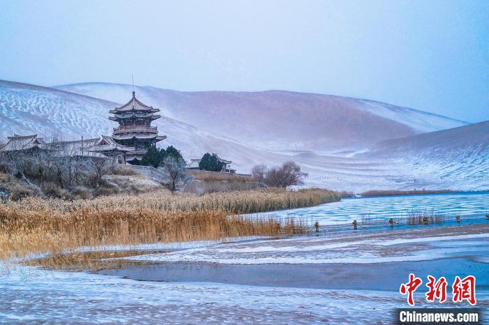 2021年11月28日，雪落鳴沙山月牙泉景區(qū)?！⊥醣筱y 攝