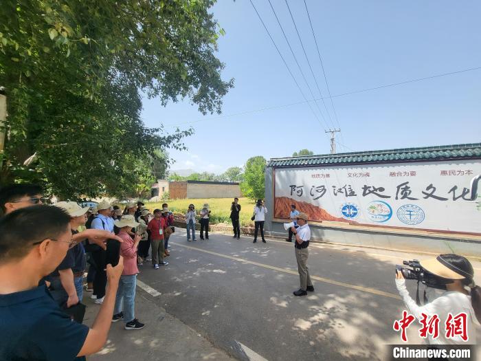 圖為中國(guó)地質(zhì)大學(xué)(北京)教授張緒教介紹村落情況?！『衍?攝
